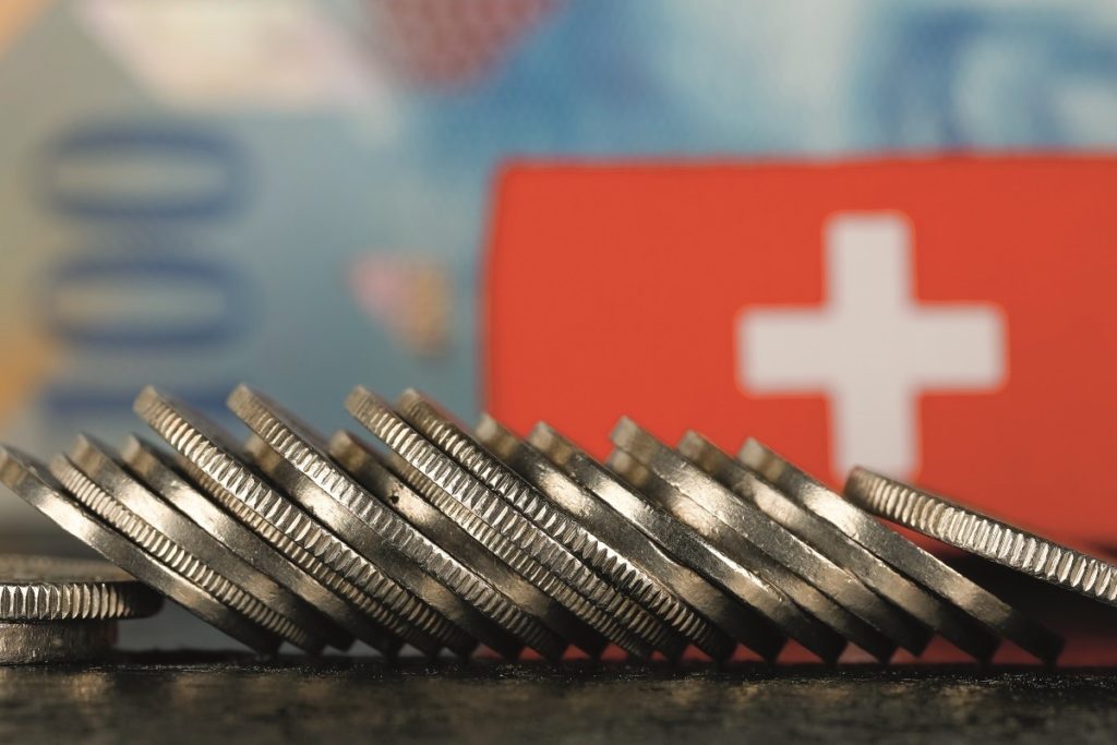 Münzen vor Schweizer Flagge