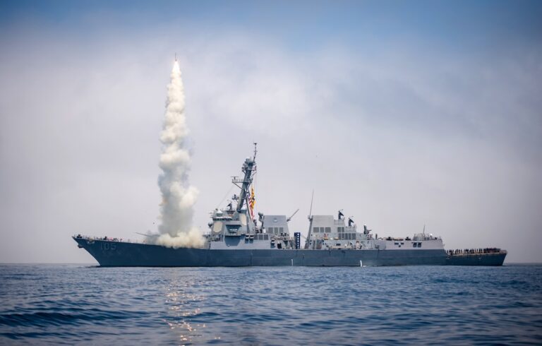 Ein Kriegsschiff, von dem eine Rakete startet.